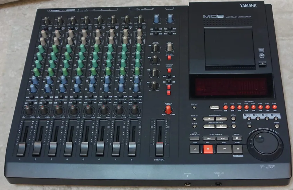 A Yamaha MD8 multitrack MiniDisc recorder: eight channel strips with faders on the left, MiniDisc transport and jog wheel on the right